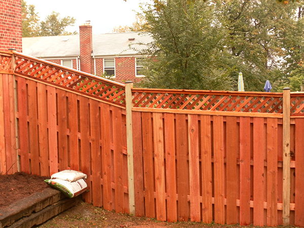 How to Build a Horizontal Plank Fence in a Hillside Backyard